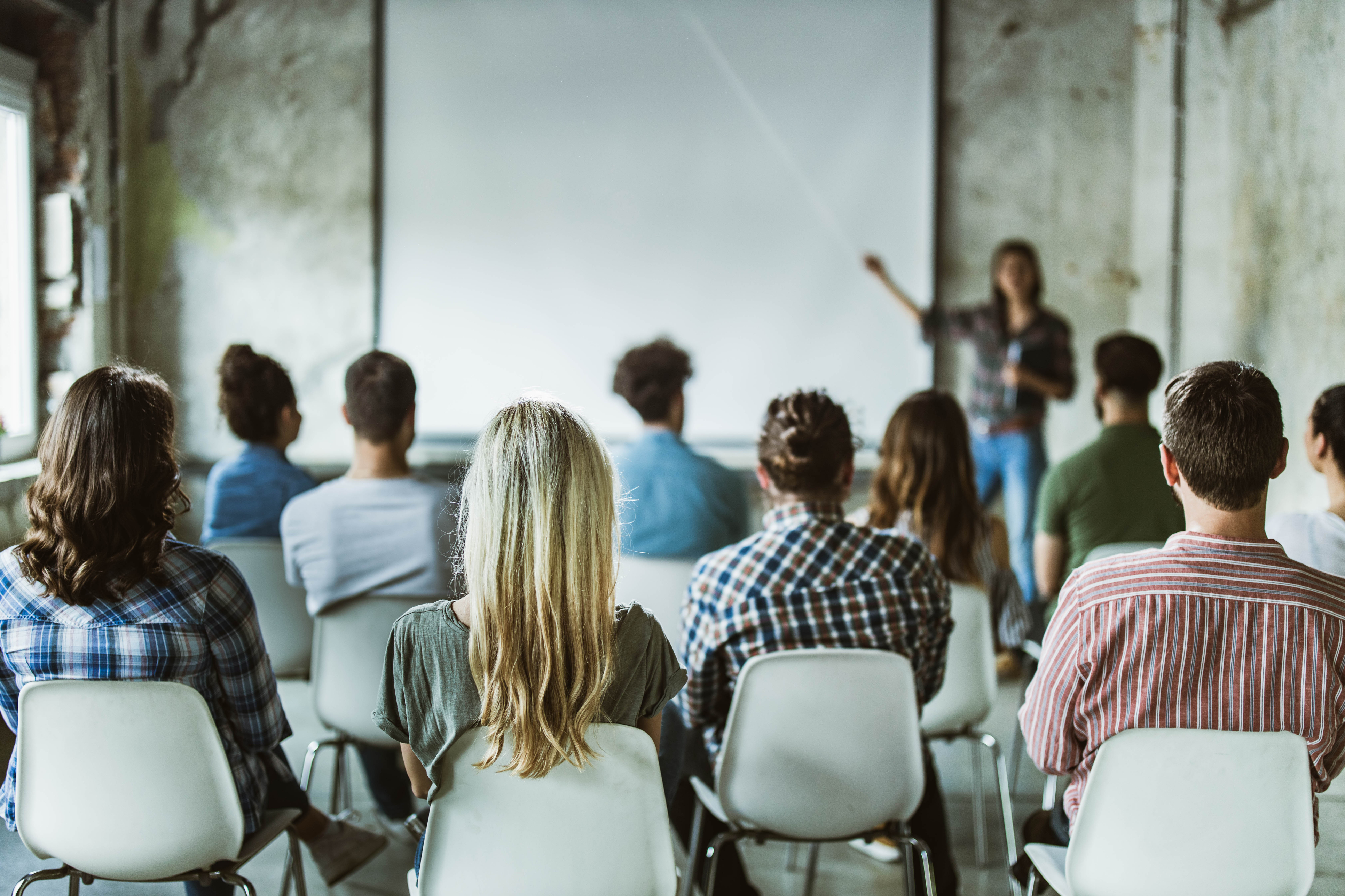 Back view of design professionals having training class in the office.